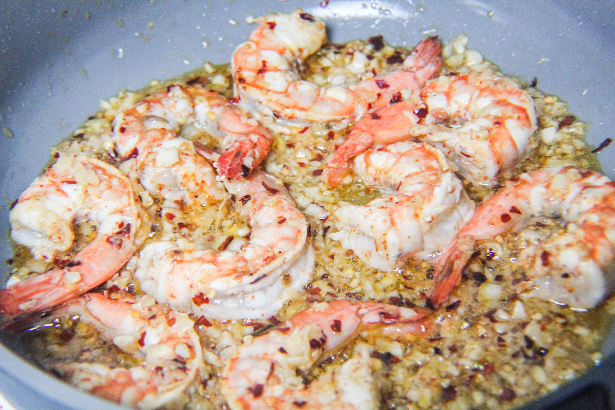 shrimp cooking in garlic sauce