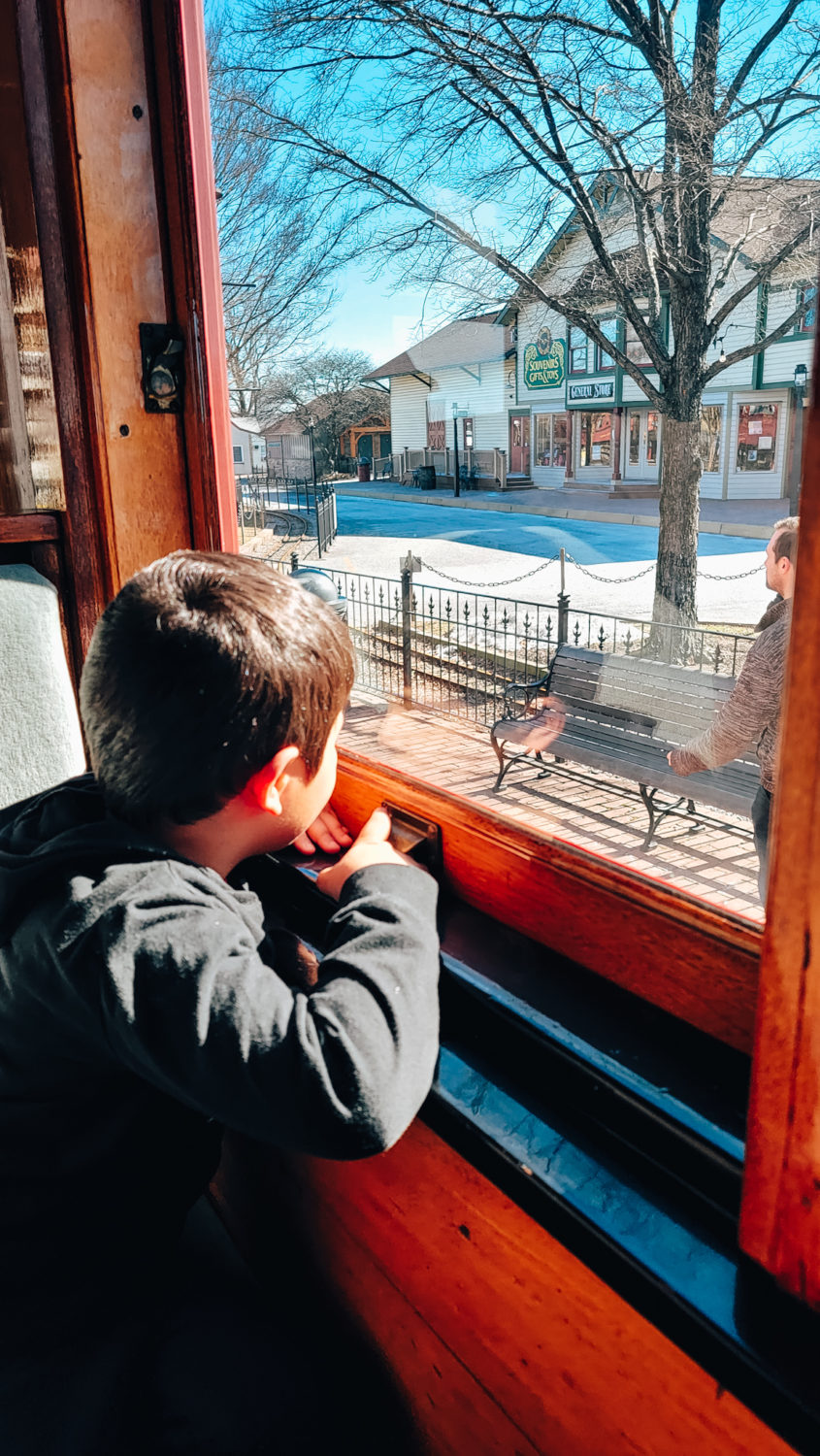 Son looking out the window on a train