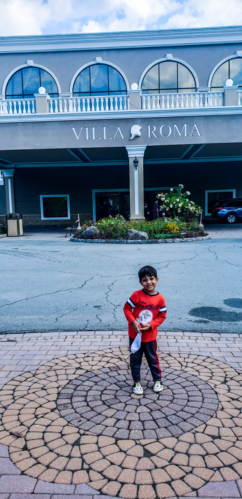 son in front if villa roma