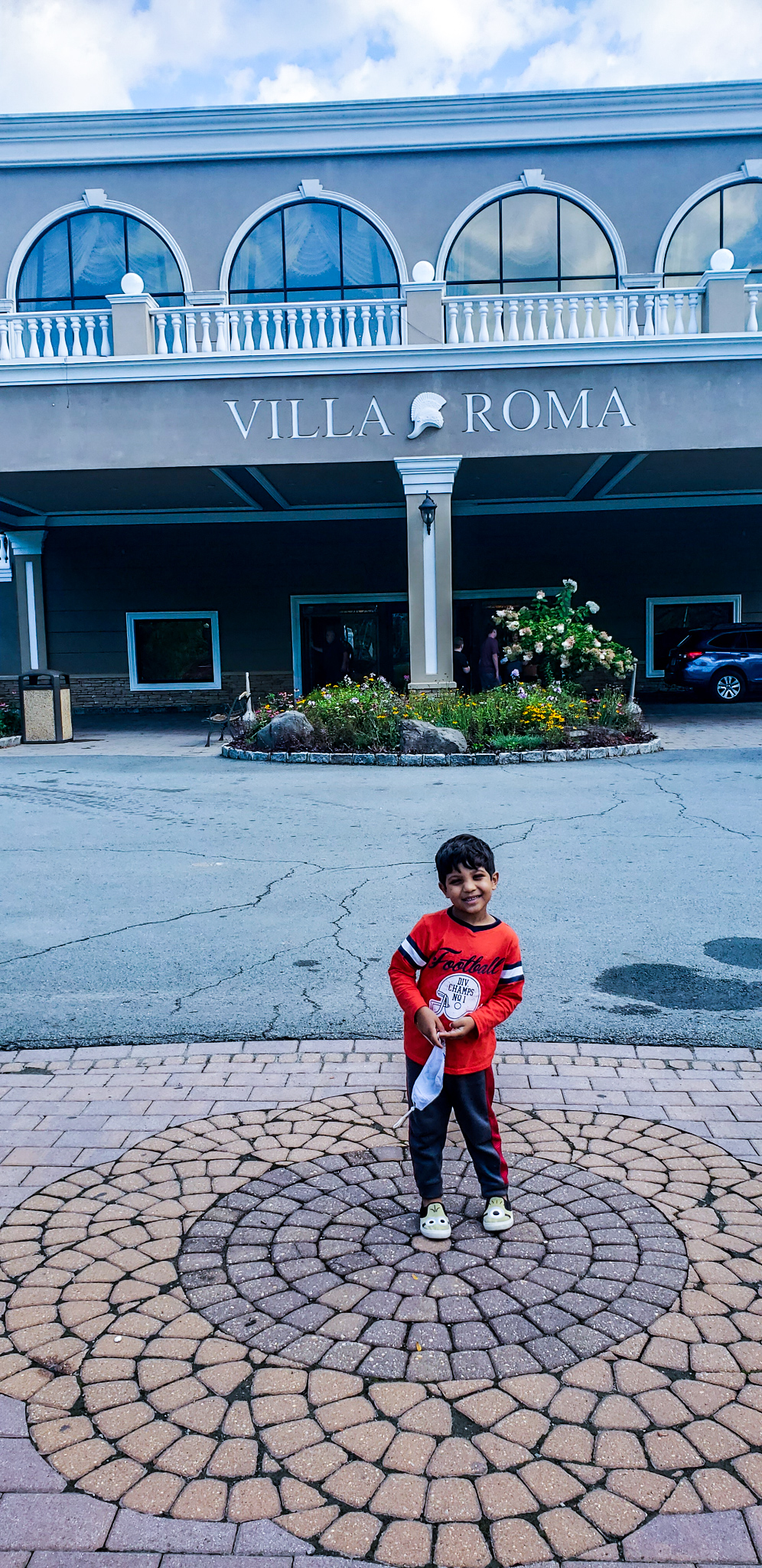 son in front if villa roma